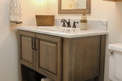 Small elegant 3/4 ceramic tile bathroom photo in Phoenix with furniture-like cabinets, medium tone wood cabinets, a one-piece toilet, gray walls, an undermount sink and marble countertops