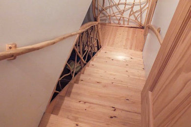 Inspiration for a mid-sized wooden staircase remodel in Other with wooden risers