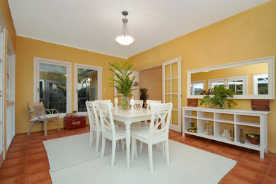 This is an example of an eclectic dining room in Brisbane.