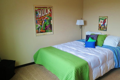 Example of a mid-sized minimalist boy carpeted kids' room design in Other with beige walls