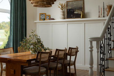 Inspiration for a transitional medium tone wood floor, brown floor, wall paneling and vaulted ceiling dining room remodel in Louisville with white walls