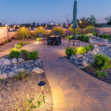 Backyard Patio with Spacious Lawn & Dry Stream Bed