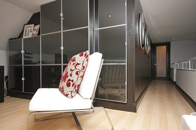 Inspiration for a mid-sized transitional freestanding desk light wood floor home studio remodel in Toronto with gray walls