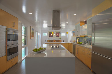 Example of a minimalist kitchen design in DC Metro with black appliances