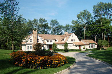 Elegant beige split-level vinyl exterior home photo in New York
