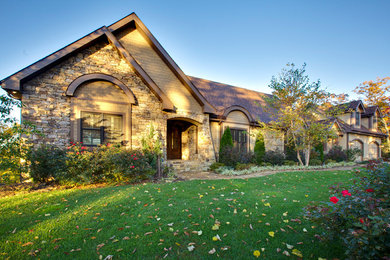 Large elegant beige two-story mixed siding exterior home photo in Other
