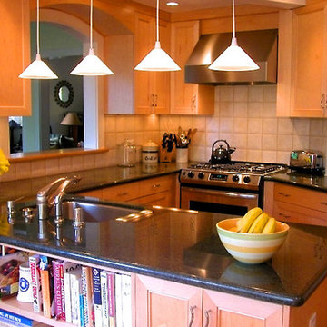 Kitchen overview with peninsula, pass-through, and bookshelves