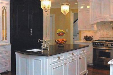Mid-sized elegant u-shaped medium tone wood floor eat-in kitchen photo in Chicago with an undermount sink, beaded inset cabinets, white cabinets, marble countertops, white backsplash, subway tile backsplash and stainless steel appliances