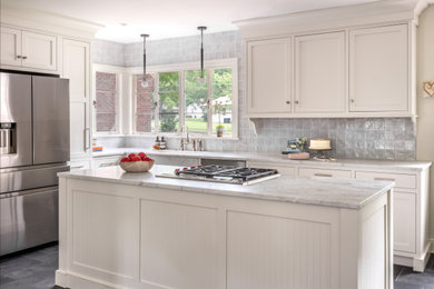 Mid-sized transitional l-shaped cement tile floor and gray floor eat-in kitchen photo in Other with a drop-in sink, shaker cabinets, white cabinets, quartzite countertops, gray backsplash, porcelain backsplash, stainless steel appliances, an island and multicolored countertops