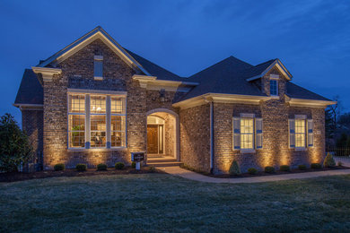Inspiration for a huge contemporary two-story brick exterior home remodel in St Louis