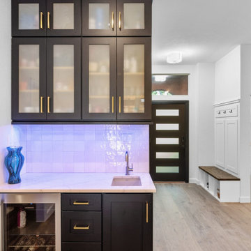 Black Cabinetry with Gold Accents and Integrated Beverage Chiller