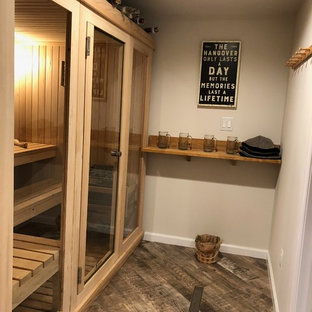 This is an example of a medium sized rustic fully buried basement in Baltimore with grey walls, porcelain flooring, no fireplace and grey floors.