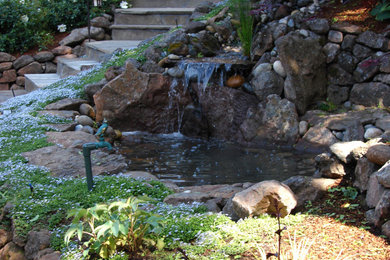 Inspiration for a traditional backyard stone landscaping.