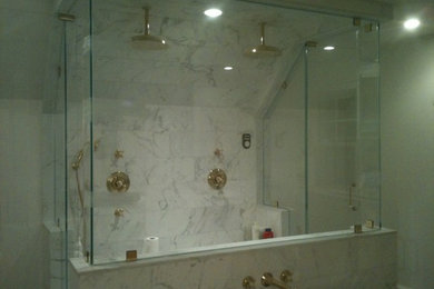 Inspiration for a transitional bathroom in New York with a double shower, gray tile, white tile and stone tile.