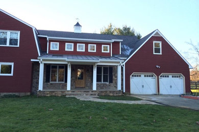 Example of a farmhouse exterior home design in New York