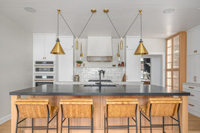 Transitional l-shaped light wood floor, beige floor and shiplap ceiling kitchen photo in Atlanta with an undermount sink, shaker cabinets, white cabinets, gray backsplash, white appliances, an island and gray countertops
