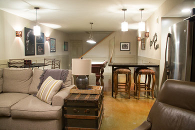 Basement - large transitional underground concrete floor basement idea in Other with beige walls