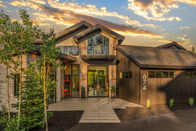 Example of a mountain style brown two-story wood exterior home design in Denver with a shingle roof and a brown roof