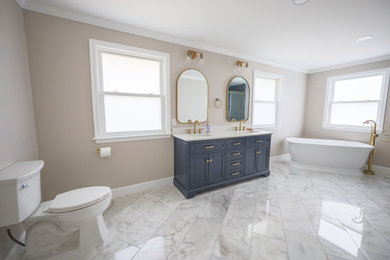 Inspiration for a large modern master blue tile and ceramic tile ceramic tile, white floor and double-sink bathroom remodel in Philadelphia with recessed-panel cabinets, blue cabinets, a two-piece toilet, gray walls, an undermount sink, marble countertops, white countertops, a niche and a freestanding vanity