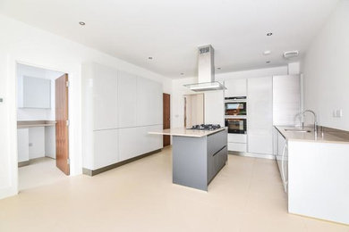 Design ideas for a medium sized contemporary l-shaped open plan kitchen in Hertfordshire with an island.