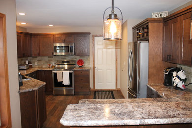 Inspiration for a mid-sized timeless l-shaped vinyl floor and brown floor eat-in kitchen remodel in Other with an undermount sink, shaker cabinets, dark wood cabinets, laminate countertops, multicolored backsplash, ceramic backsplash, stainless steel appliances, a peninsula and multicolored countertops