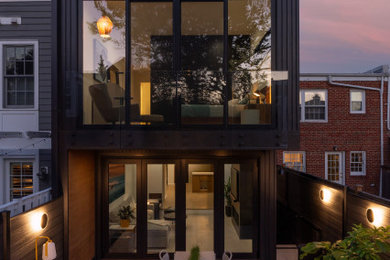 Small contemporary gray two-story concrete fiberboard and board and batten exterior home idea in DC Metro