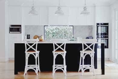 This is an example of a traditional kitchen in Sydney with with island.