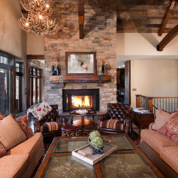 Reclaimed Wood Mantel with Metal Straps on Brick Fireplace in Grand Living Room