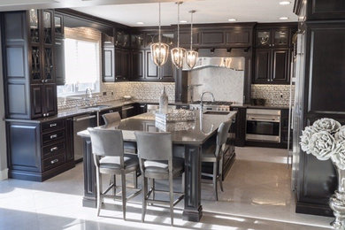 Inspiration for a traditional u-shaped kitchen in Calgary with an undermount sink, raised-panel cabinets, dark wood cabinets, quartz benchtops, white splashback, marble splashback, stainless steel appliances, porcelain floors, with island and grey floor.