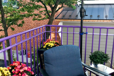Inspiration for a mid-sized industrial apartment and metal railing balcony remodel with no cover