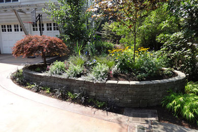 Photo of a mid-sized traditional front yard driveway in Seattle with concrete pavers.