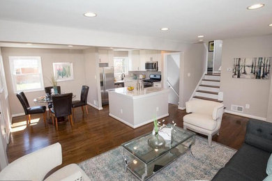 Inspiration for a small modern loft-style dark wood floor and brown floor family room remodel in DC Metro with beige walls