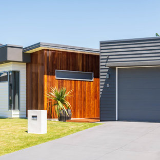 Inspiration for a contemporary one-storey grey house exterior in Brisbane with mixed siding and a flat roof.