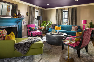 Example of an eclectic enclosed medium tone wood floor and brown floor living room design in New York with beige walls, a standard fireplace and no tv