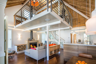 Small loft-style medium tone wood floor living room photo in Salt Lake City with white walls, a standard fireplace, a stone fireplace and no tv