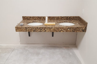 Example of a large transitional 3/4 brown tile and ceramic tile bathroom design in Other with a one-piece toilet, quartzite countertops and brown countertops