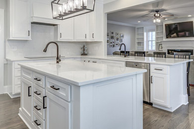 Eat-in kitchen - mid-sized contemporary u-shaped eat-in kitchen idea in Raleigh with shaker cabinets, white cabinets, quartzite countertops and an island