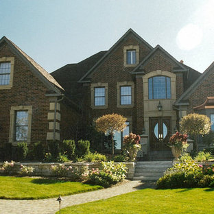 This is an example of a medium sized country galley utility room in Chicago with a submerged sink, beaded cabinets, white cabinets, engineered stone countertops, beige walls, brick flooring, a side by side washer and dryer, pink floors and white worktops.