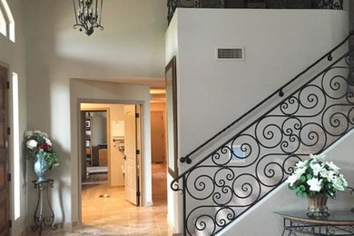 Transitional travertine floor entryway photo in Phoenix