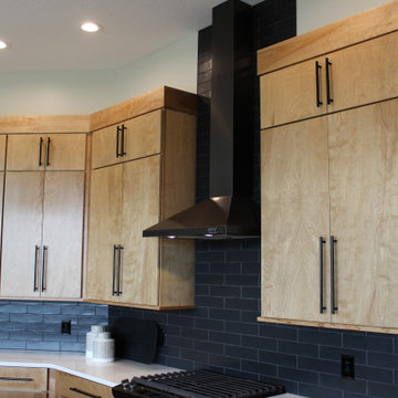 Angled Kitchen Design with Slab Style Cabinets in Pecan Stain