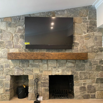 TV Mounted on Stone Fireplace with Attached Soudbar