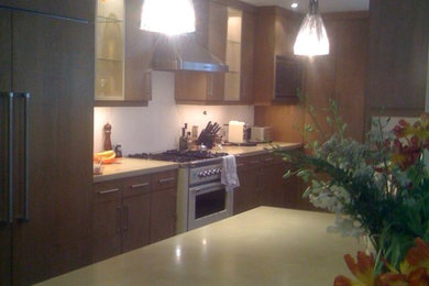 Kitchen - contemporary kitchen idea in Montreal with medium tone wood cabinets and concrete countertops