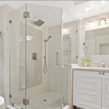 All White Bathroom With Neo-Angle Glass Shower and Vanity