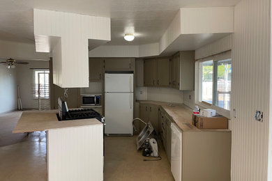 Mid-sized cottage l-shaped eat-in kitchen photo in San Francisco with recessed-panel cabinets, white cabinets, wood countertops, white backsplash, wood backsplash and an island