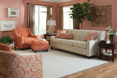 Design ideas for a mid-sized transitional formal enclosed living room in Other with pink walls, light hardwood floors, no fireplace and no tv.