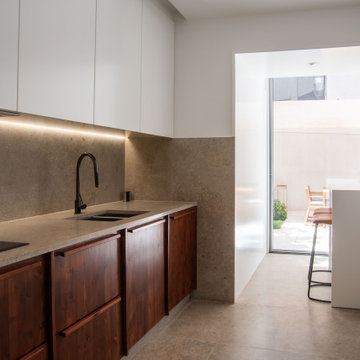 Kitchen with Wood Base Cabinets in Picoas Apartment