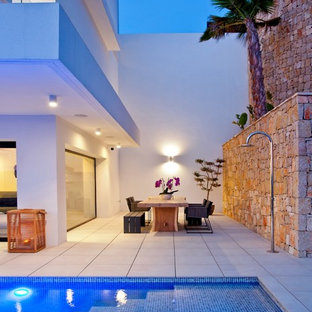 Inspiration for a mid-sized mediterranean side yard patio in Other with an outdoor shower, tile and no cover.