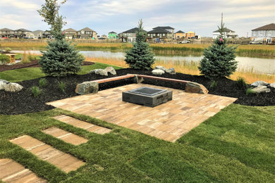 Design ideas for a concrete paver landscaping in Other with a fire pit.