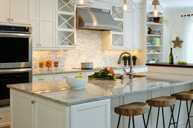 Kitchen - transitional ceramic tile kitchen idea in Miami with an undermount sink, recessed-panel cabinets, white cabinets, granite countertops, beige backsplash, matchstick tile backsplash, stainless steel appliances and an island