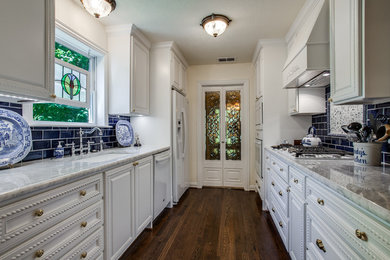 Inspiration for a traditional kitchen in Dallas with a single-bowl sink, beaded inset cabinets, white cabinets, marble benchtops, blue splashback, subway tile splashback, stainless steel appliances, medium hardwood floors and white benchtop.